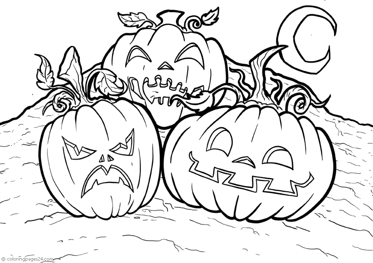 Three big halloween pumpkins lying on the ground.
